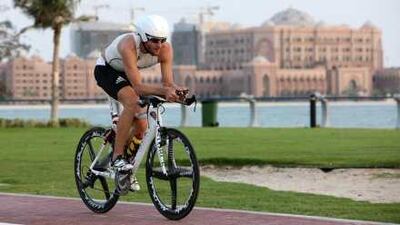 Faris al Sultan, the captain of Team Abu Dhabi Triathlon, trains along the waterfront in the capital.