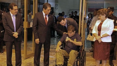 Jose Salvador Alvarenga arrives at the airport in San Salvador, El Salvador, Tuesday. Alvarenga was wheeled in a wheelchair before a crush of more than 100 mostly foreign journalists. El Salvador's Foreign Ministry/AP Photo