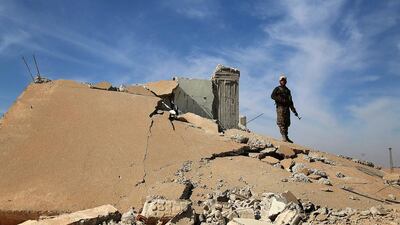 A Syrian Democratic Forces (SDF) fighter stands with his weapon on the rubble of a destroyed building, north of Raqqa city, Syria November 7, 2016. REUTERS/Rodi Said