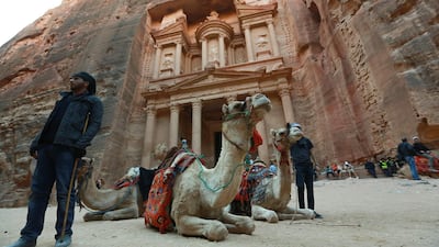 Jordanians offer camel rides for tourists in front of the ancient Khaznah (treasury) monument. AFP