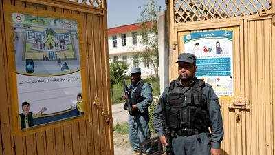 Afghan policemen stand guard at a gate of a voter registration centre for the upcoming parliamentary and district council elections in Kabul, Afghanistan April 23, 2018. Mohammad Ismail / Reuters