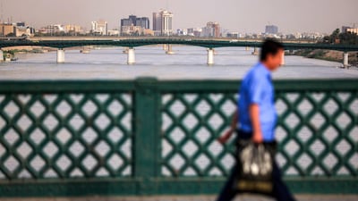 A man crosses the Ahrar Bridge along the Tigris in Baghdad on May 4. Unlike some of its fellow energy producers, Iraq lacks the financial cushion of trillion-dollar sovereign wealth fundsy. AFP
