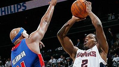 Atlanta Hawks' Joe Johnson, right, shoots against Charlie Villanueva of the Detroit Pistons.