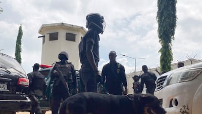 Officers stand guard outside the Kuje prison. AP