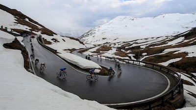 Riders descend after crossing the Splugen Pass during Stage 20. AFP