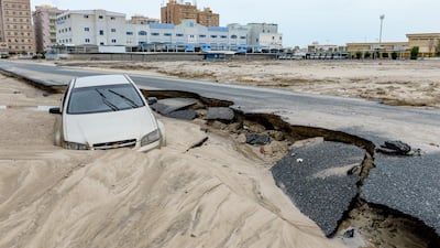 A car is swept away on a damaged road following heavy rain in Kuwait City, Kuwait, 15 November 2018. EPA/NOUFAL IBRAHIM