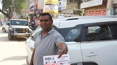 A man distributing flyers for a consultancy centre in Jalandhar in Punjab, India
