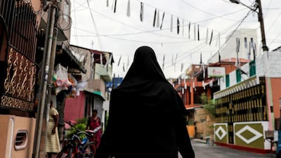 A Muslim woman wearing a hijab walks through a street near St Anthony's Shrine, days after a string of suicide bomb attacks across the island on Easter Sunday, in Colombo, Sri Lanka. Reuters