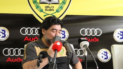 Diego Maradona kisses his phone when he took a call from his grandson during a press conference.