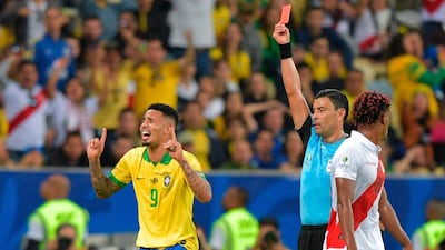 Chilean referee Roberto Tobar shows the red card to Brazil's Gabriel Jesus after a second yellow. AFP