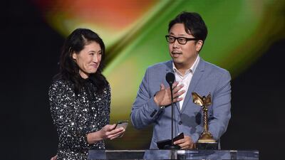 Teruhisa Yamamoto, right, accepts the Best International Film award for 'Drive My Car'. AFP
