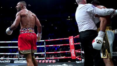 Kell Brook, left, celebrates after the referee stepped in to end the fight against Amir Khan in round six. AP