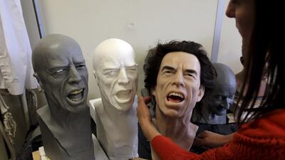 Helene Jonca, one of the painters at the Paris Grevin Wax Museum checks the wax statue of Rolling Stones lead singer Mick Jagger in their workshop in Paris on April 4, 2014. Philippe Wojazer / Reuters