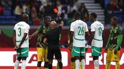 Mali's Yves Bissouma is shown a red card by referee Abongile Tom. Reuters