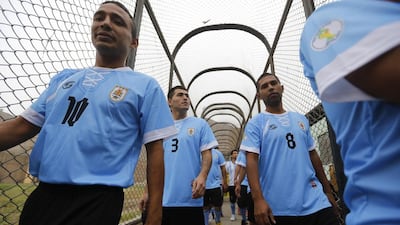 Prisoners, wearing jerseys in the colours of the Uruguay national football team, participate in their own prisoner World Cup at the Castro-Castro prison in Lima on Monday. Mariana Bazo / Reuters / June 2, 2014
