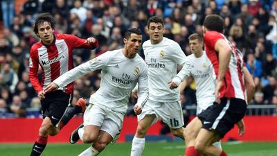 Real Madrid's Cristiano Ronaldo, second from left, runs with the ball during their La Liga match against Athletic Club Bilbao at the Santiago Bernabeu stadium in Madrid on February 13, 2016. / AFP / GERARD JULIEN