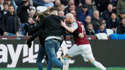 Fans clash with West Ham United's James Collins after invading the pitch. David Klein / Reuters