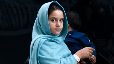 An Afghan woman evacuated from Kabul in the terminal before boarding a bus after arriving at Washington Dulles International Airport, in Chantilly, Virginia. AP Photo