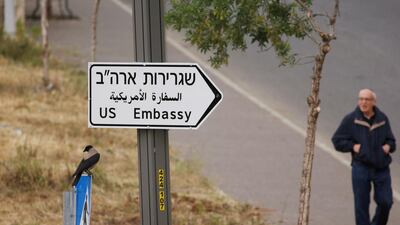 A man walks next to a road sign pointing to the US embassy, in the area of the US consulate in Jerusalem. Reuters