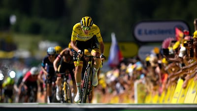 Slovenia's Tadej Pogacar crosses the finish line in Megeve, France. AP