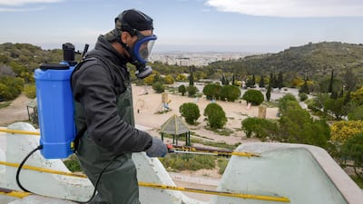 A health worker disinfects the Enahli amusement park at Ariana near Tunis. AFP