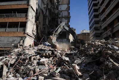 Rescuers operate an excavator as they look for survivors under the rubble, at the site of an Israeli strike in Beirut. Reuters