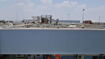 Workers fixing the damage at Abha airport. AFP
