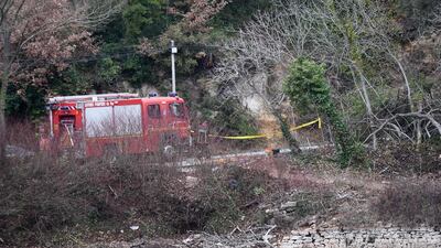 Firefighters work at the site of an accident near Carces lake, about 50 kilometres (30 miles) northwest of the resort of Saint-Tropez as the area is cordoned off after two army helicopters crashed into each other. Anne-Christine Poujoulat / AFP