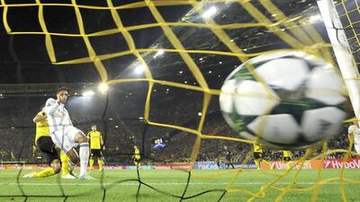 Real Madrid’s Raphael Varane, second left, scores his side’s second goal against Borussia Dortmund. Martin Meissner / AP Photo