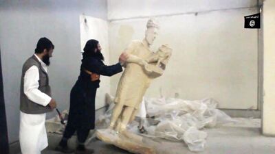 ISIL militants destroy artefacts in Mosul. AFP