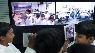 Students interact with their classmates via computer as they show off iPads (DELORES JOHNSON/The National)