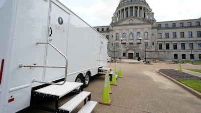 The Mississippi State Capitol dome looms over portable toilets set up in the driveway in Jackson, Mississippi. AP