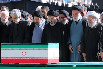 Three sons of slain Iranian supreme leader Ayatollah Ali Khamenei praying at his coffin alongside Iranian officials. AFP