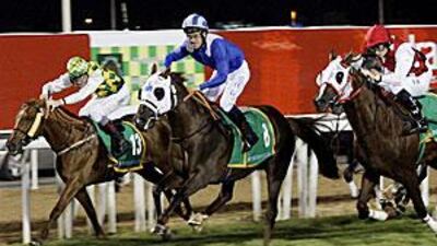 Richard Hills, in the blue, is in action in Jebel Ali this afternoon on Aamaaq.
