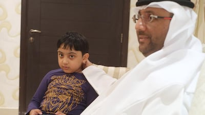 Anwar Alawadhi and his son, Mansour, who he claims was hit on one of his arms at his school by a teacher. Adec has begun an investigation in a bid to discover exactly what happened. Delores Johnson / The National