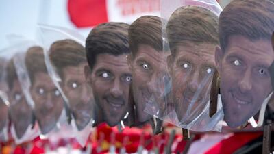 Masks of Steven Gerrard are displayed for sale outside the stadium. Oli Scarff / AFP