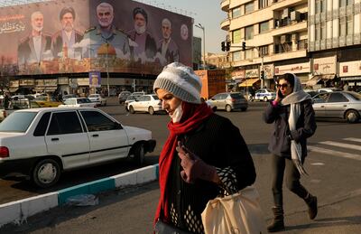 Pedestrians at Islamic Revolution square near a banner showing the late commander of the Iran's Revolutionary Guard expeditionary Quds Force, Qassem Suleimani, centre, and Hezbollah and Hamas officials killed by Israel, in Tehran, Iran, on January 21. AP