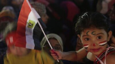 A child waves an Egyptian flag on the third day of voting in Egypt's presidential election. Asmaa Waguih / Egypt