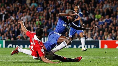 Patrice Evra brings down Chelsea's Brazilian midfielder Ramires in the final minutes of the first leg last week. The Manchester United left-back said the team are not focusing on winning a trophy treble, just winning every game they play.