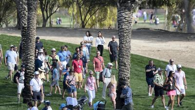 Spectators watch players in action at the Emirates Golf Club.