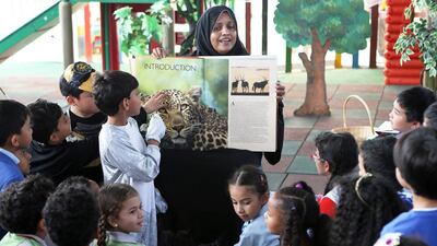 Tanveer Arshad, managing director of the AJ Group of Schools, reads the book ‘Africa‘ to Grade 2 students.