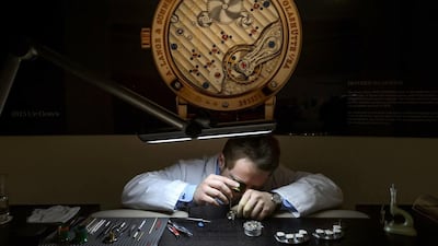An employee of German watchmaker A Lange & Soehne assembles a wristwatch. Fabrice Coffrini / AFP