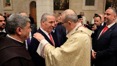 Hussein Al Sheikh, Vice President of the Palestinian Authority, centre, greets Latin Patriarch of Jerusalem Cardinal Pierbattista Pizzaballa during a Christmas midnight mass in the Church of the Nativity in the Israeli-occupied West Bank city of Bethlehem. AFP