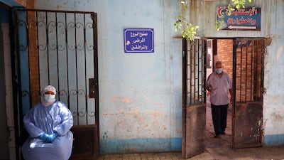 Medical personnel sit outside at the Imbaba Fevers Hospital in Cairo, Egypt. EPA
