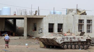 A supporter of the Southern Transitional Council walks through a military camp taken from government troops in the northern Dar Saad district of Aden on January 31, 2018. Saleh Al Obeidi / AFP