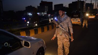 An Afghan soldier stops a vehicle at a checkpoint in Herat after a night curfew was imposed across 31 of Afghanistan's 34 provinces. AFP