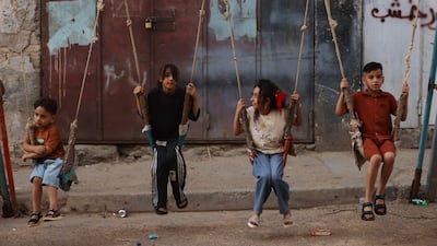 Children use the swings at an amusement park in the alleys of Al Shawaka, in the Iraqi capital of Baghdad. AFP