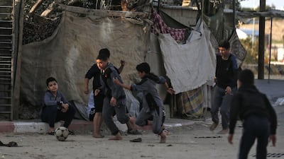 Palestinian children play football at a refugee camp in Khan Yunis in the southern Gaza Strip. AFP