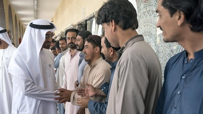 Sheikh Mohammed bin Zayed greets staff at the carpet market in Mina Zayed Port area. Ryan Carter for the Crown Prince Court - Abu Dhabi