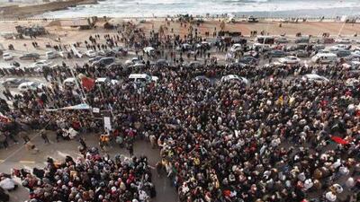 Anti-Qaddafi demonstrater in Benghazi, Libya, yesterday. Army units and militiamen loyal to Muammar Qaddafi struck back against rebellious Libyans who have risen up in cities close to the capital, attacking a mosque where many were holding an anti-government sit-in and battling others who seized control of an airport.